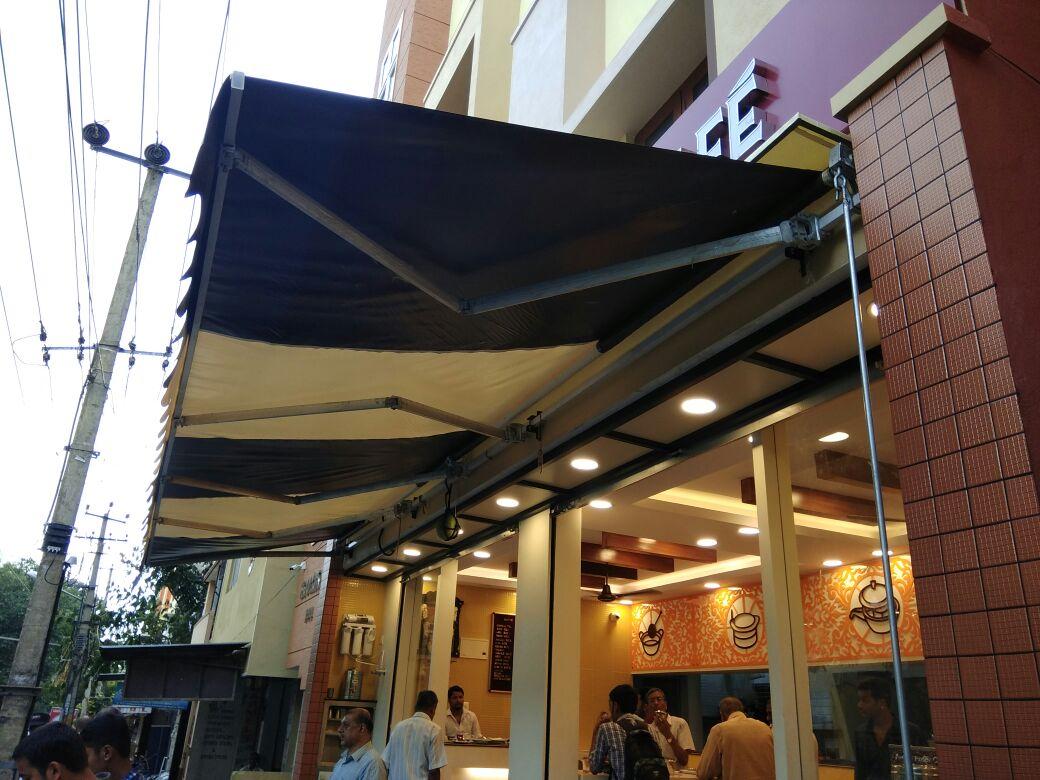 Manual awning for shop - golden awning tensile